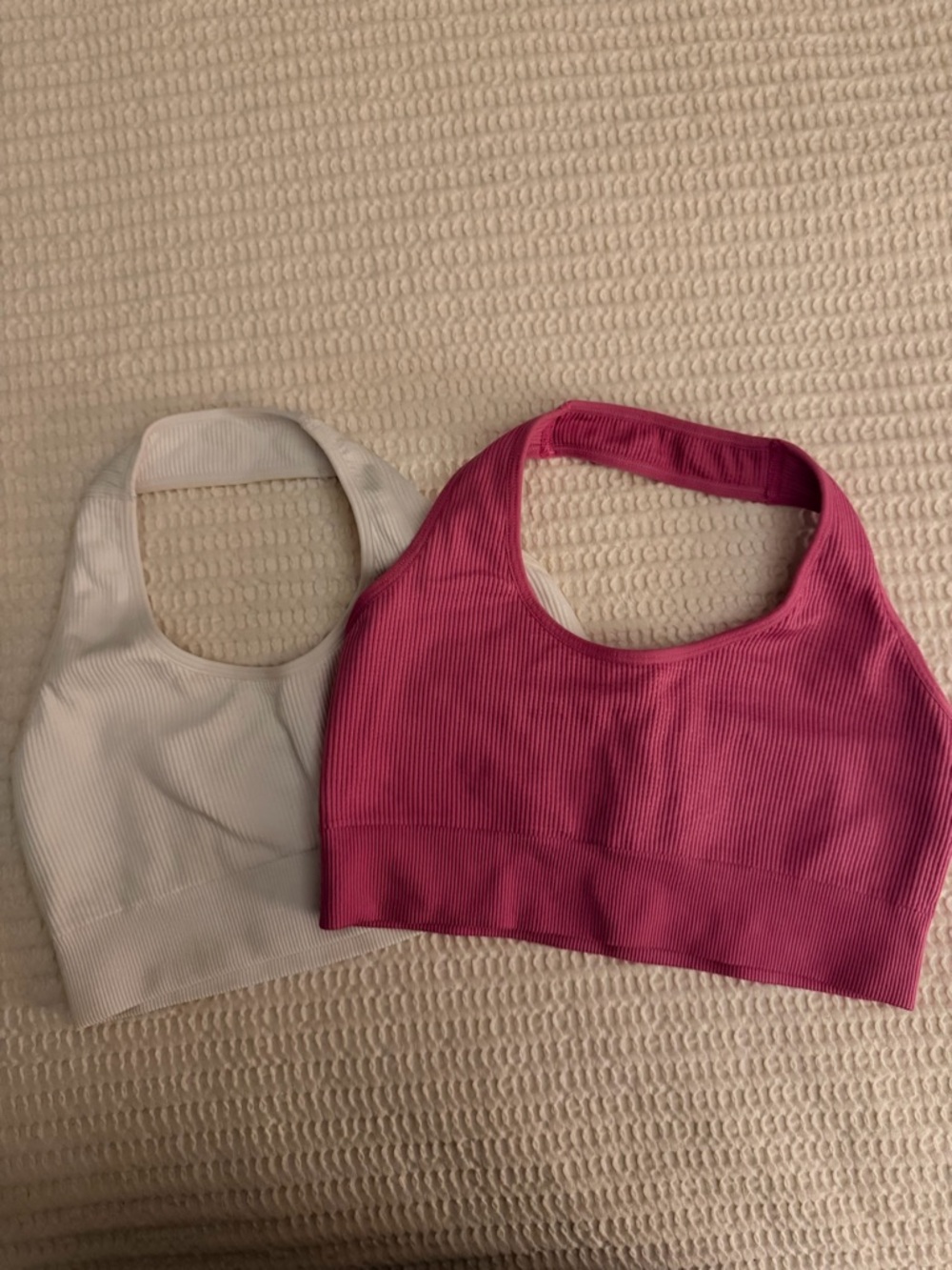 Pair of NVGTN Halter Neck Sports Bras in White and Hot Pink